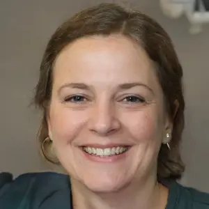 Portrait of a happy, smiling woman showing healthy-looking nails.